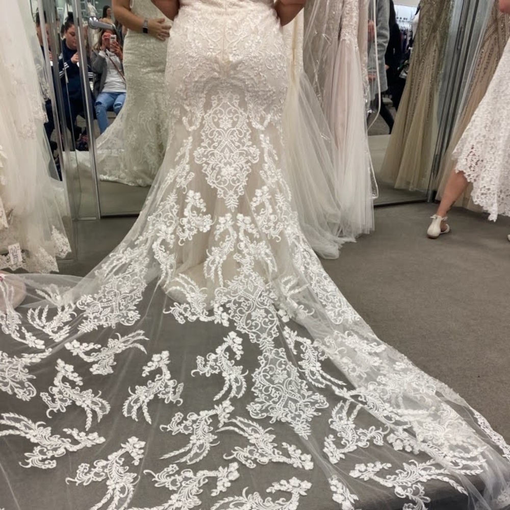 Ivory Oleg Cassini brand Size 20 never worn or altered. Asking $600 with veil.
